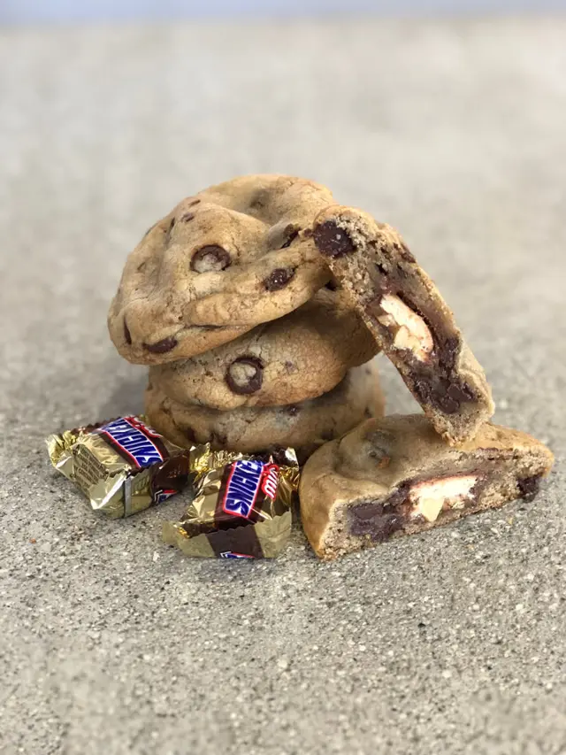 Stuffed cookie broken open with candy pieces