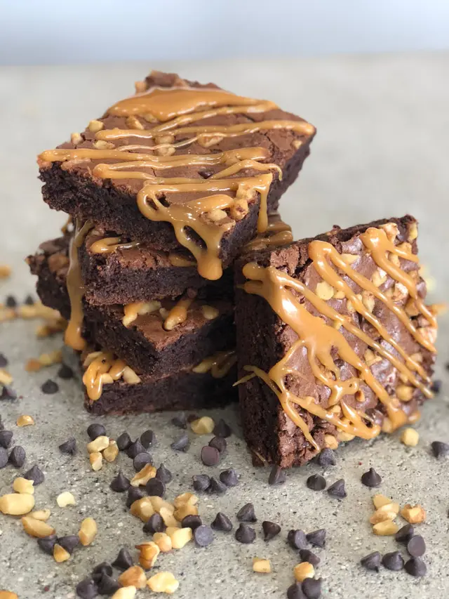 Stacked turtle brownies with caramel drizzle