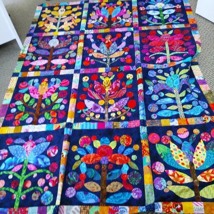 Bright appliqué quilt blocks laid out