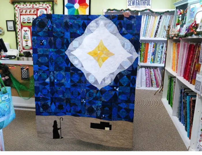 Blue quilt with a center diamond medallion