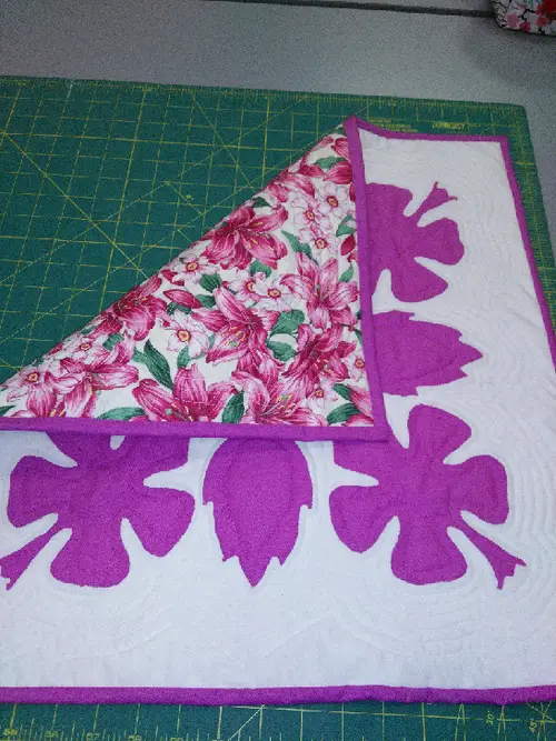 Pink and white appliqué quilt