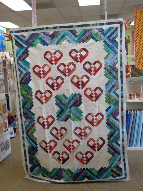 Teal and red appliqué quilt