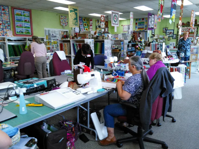 Open workspace with sewing machines and fabric walls