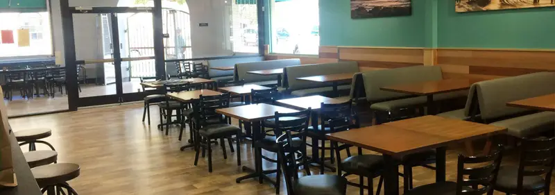 Dining room with booths and tables at Spencer Makenzie's (photo from the restaurant's About page)