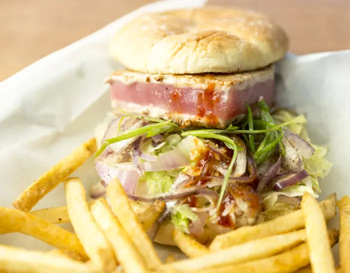 The Parker Burger, a seared ahi tuna steak burger, with fries