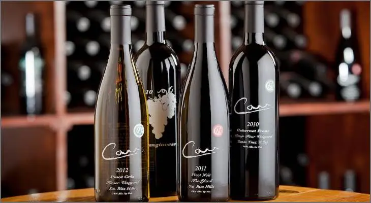Wine bottles standing on a barrel