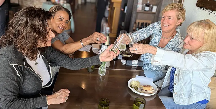 Friends toasting with wine at Social Hour